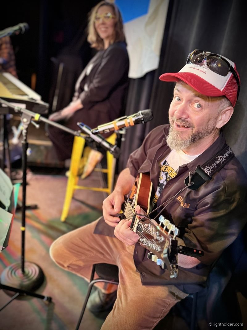 A grinning Seán Lightholder plays mandolin